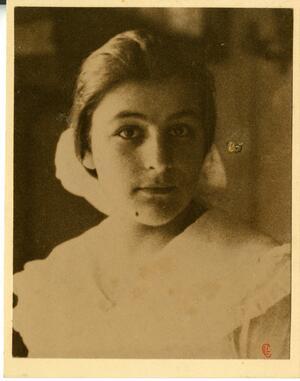 A  young Ida Weis Friend, wearing a white dress and bonnet