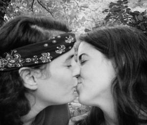 Photograph of Joan Biren kissing her lover, Sharon.