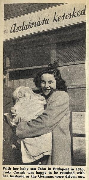 Newspaper picture of Judy Cassab holding a baby