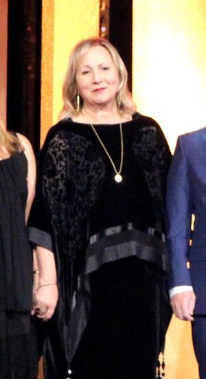 Mimi Leder wearing a black dress, smiling at Peabody Awards
