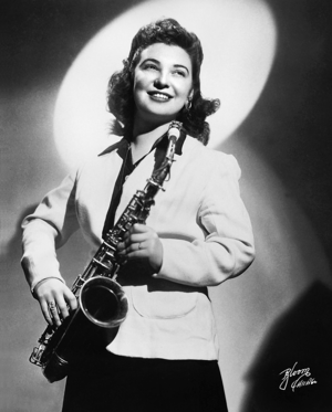 Studio portrait of Roz Cron holding an alto saxophone