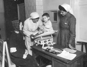 Nurses in the Warsaw Ghetto Weigh a Baby