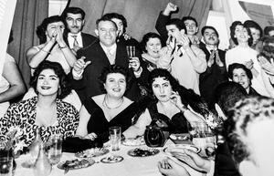 Zohra El Fassia, center right, in a large party of people smiling and clapping