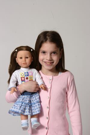 A Girl Holding a Gali Girls Doll