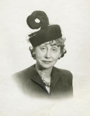 A portrait of Adeline Schulberg wearing a black hat