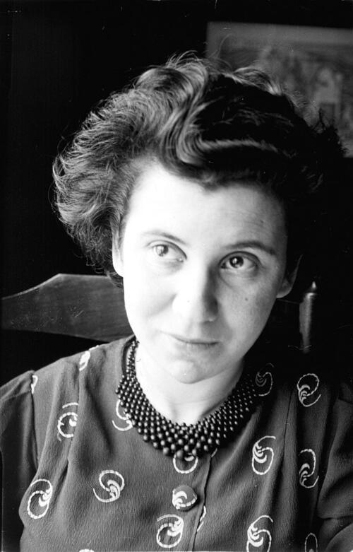 Portrait of Etty Hillesum, sitting in a chair and looking off-camera