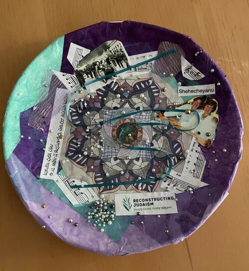 Purple and aqua plate with sheet music, text in English and Hebrew, pearl beads, and ribbon