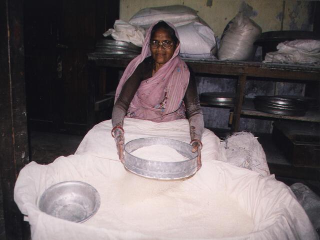 Simcha Aptker (Bnei Yisrael) sifts the community's matzo flour before Passover 2000