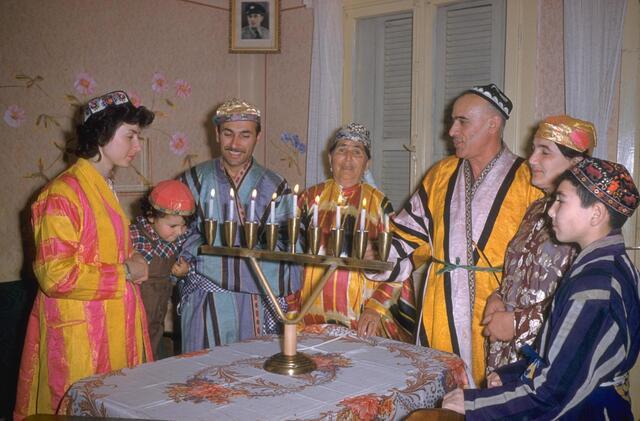 Four generations of the Kalantarov family of the Bukharan community light the Hanukkah candles in their home in Tel Aviv, 1959.