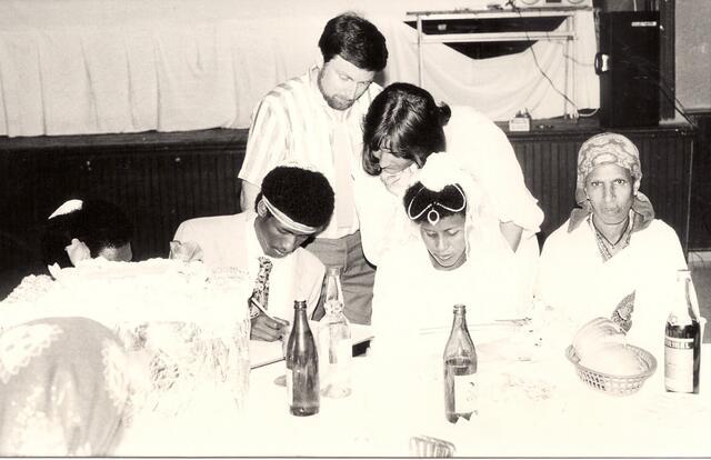 An Ethiopian Jewish couple signing wedding marriage contract (ketubah)