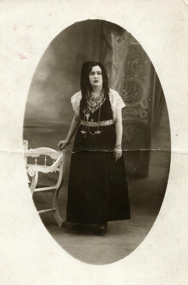 Close-up studio portrait of an Algerian Jewish woman wearing traditional garb. Circa 1930s.