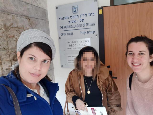Three women stand outside Tel Aviv Rabbinical Court