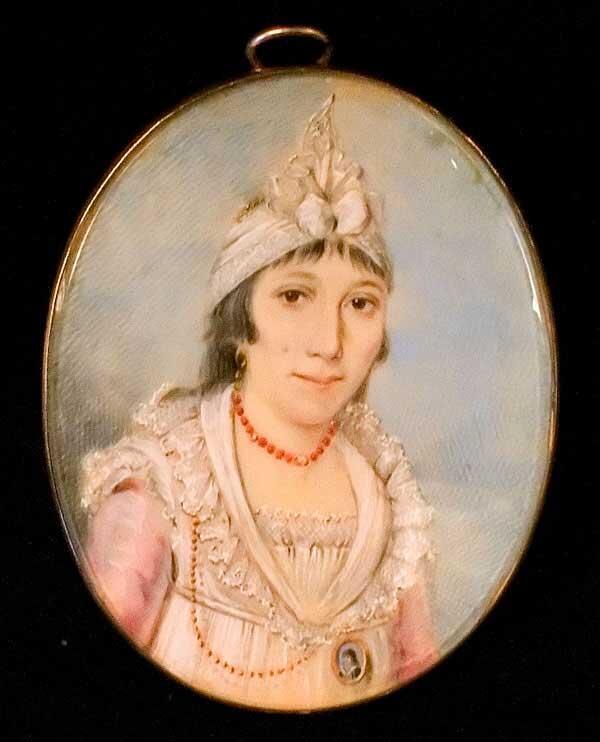 A miniature portait of Sarah Moses Levy wearing a pink dress and turban, with a small miniature attached to her dress with a chain