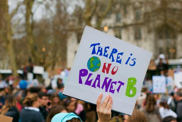 Protester Holding Sign, "There is No Planet B."