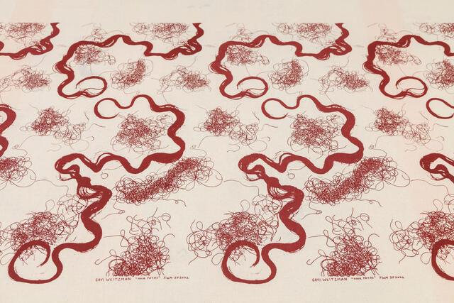 Artwork shows swirls and clusters of dark red ink, resembling hair