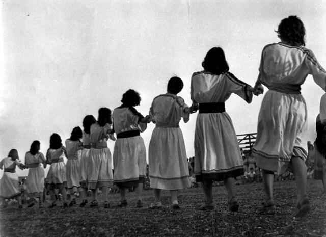 Row of women dancing with backs to camera