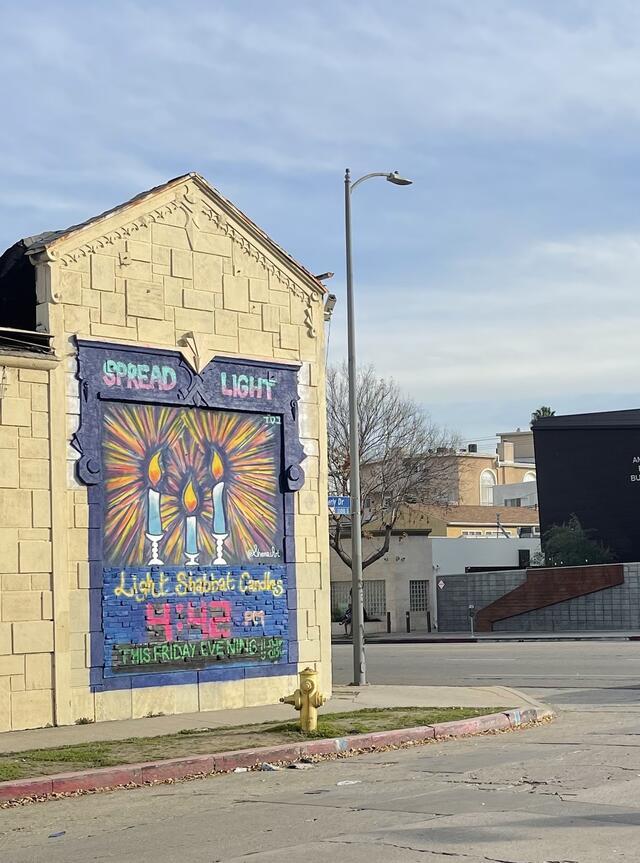 Mural that says "Spread Light - Light Shabbat Candles"