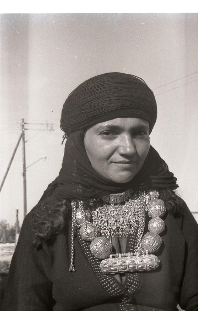 A woman wears jewelry handmade by a goldsmith in Hatzermat, Yemen. 1964. 