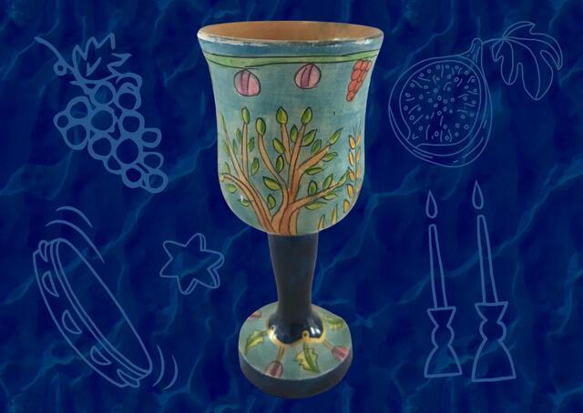 Blue kiddush cup on dark blue patterned background