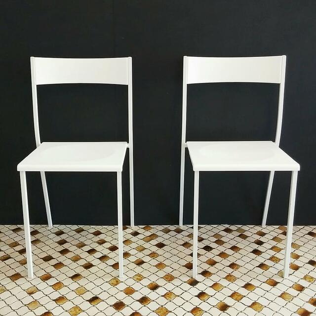 White chairs against a black wall