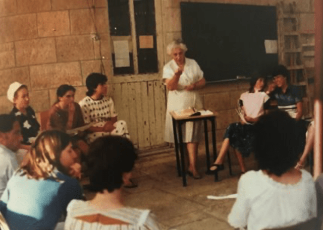 Alice Shalvi at the Pelech School - woman standing with other people seated around her
