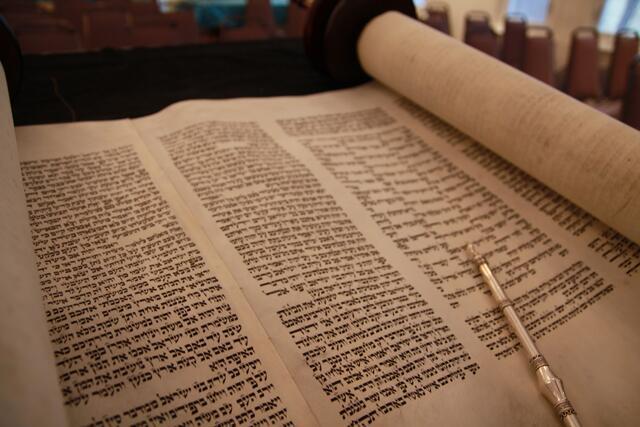 Open Torah scroll with yad.