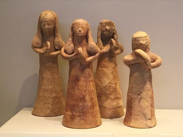 Four 6-8 inch tall terracotta figurines of women holding hand drums